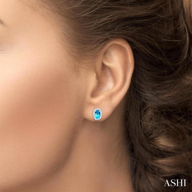 5x3 MM Oval Shape Blue Topaz and 1/8 Ctw Round Cut Diamond Halo Semi-Precious Stud Earrings in 10K White Gold