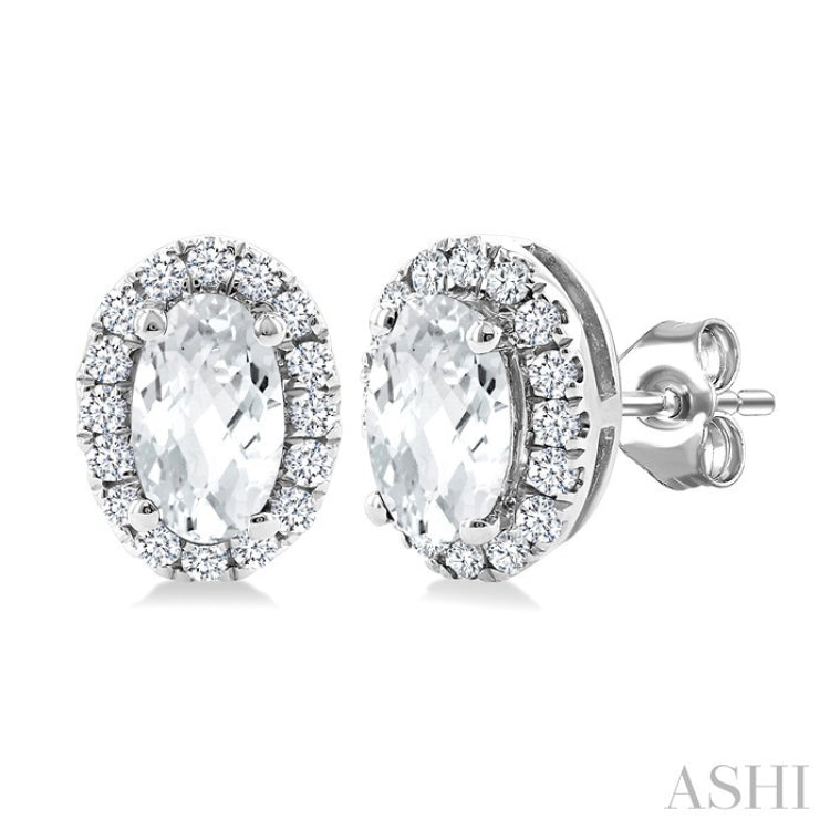 5x3 MM Oval Shape White Topaz and 1/8 Ctw Round Cut Diamond Halo Semi-Precious Stud Earrings in 10K White Gold